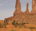 Monument Valley buttes and people on horses