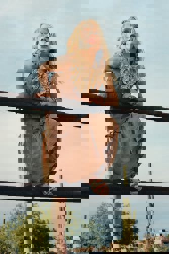 woman leaning on fence