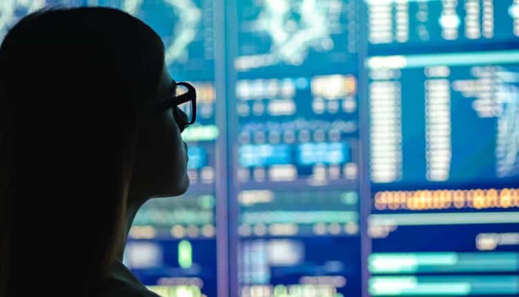 Person looking at computer screens