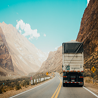 Semitruck driving between steep cliffs