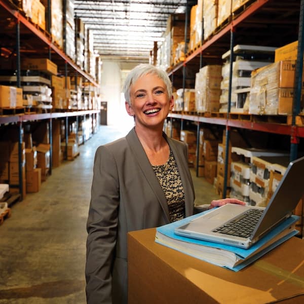 Person with computer in warehouse