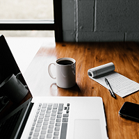 Coffee cup and computer on desk